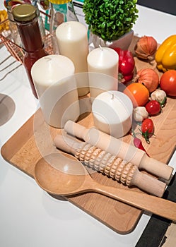 Home kitchen with cooking supplies and fake vegetables on wooden