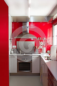 Home kitchen in red colors natural window light
