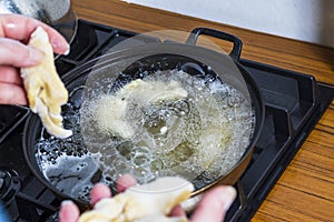 Home kitchen. On the stove of the pan in it, hot oil is thrown into it for frying