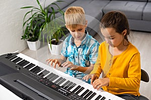 Home lesson on music for kids on the piano. The idea of activities for the child at home during quarantine. Music