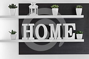 Home letters decor on white shelf