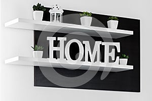 Home letters decor on white shelf