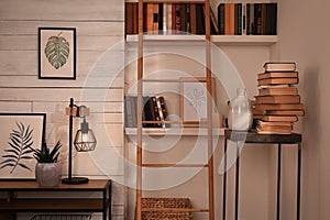 Home library interior with modern furniture and collection of different books on shelves