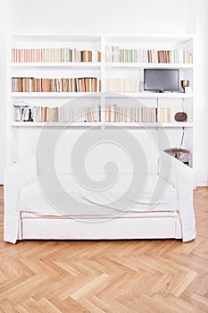 Home library with sofa or couch in white living room