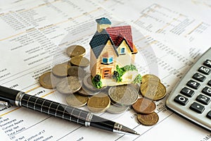 Home loan bank debit statement with house miniature