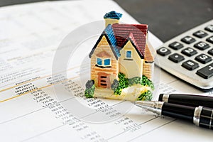 Home loan bank debit statement with house miniature