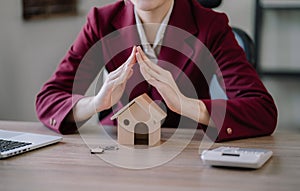 home loan officer gives the house keys to the client after signing a real estate contract with an approved mortgage application