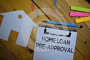 Home Loan Pre-Approval write on a paperwork isolated on wooden background photo