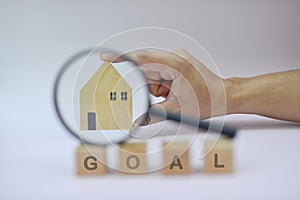 Home loans,saving for a real estate concept,Present by Magnifying glass,home and wooden cube