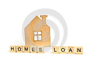 Home loans- word composed fromwooden blocks letters on White background, wooden house symbol. copy space for ad text.