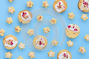 Home made almond butter and rose short bread cookies floating over blue background