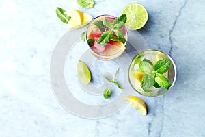 Home made Apple-Lemon and Raspberry-Lemon Lemonade with mint leaves and ice. Summer fruit drinks.