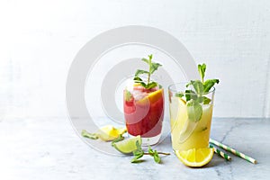 Home made Apple-Lemon and Raspberry-Lemon Lemonade with mint leaves and ice. Summer fruit drinks.