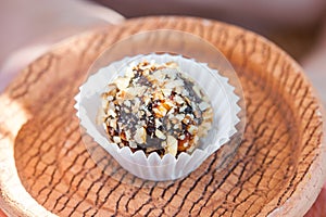 Home made candy with walnut and date on bronw clay plate