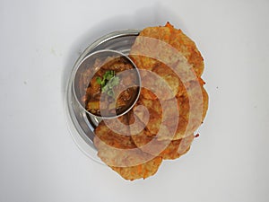 Home made Carrot Puri or Poori with Vegetable Curry in a cup with big plate isolated on white background