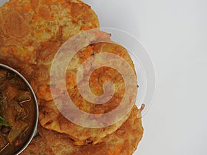 Home made Carrot Puri or Poori with Vegetable Curry in a cup with big plate isolated on white background