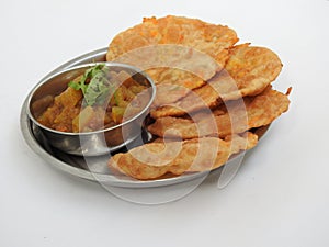 Home made Carrot Puri or Poori with Vegetable Curry in a cup with big plate isolated on white background