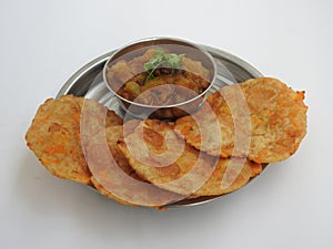 Home made Carrot Puri or Poori with Vegetable Curry in a cup with big plate isolated on white background