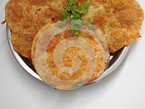 Home made Carrot Puri or Poori with Vegetable Curry in a cup with big plate isolated on white background