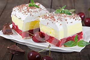 Homemade cherry cake with vanilla and whipping cream on wooden table