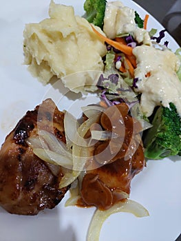 Chicken steak with mashed potato and salad