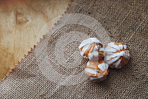 Home made choux cream on white plate. Over on wood table. Top view. with a white glaze. on wooden background.