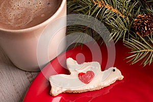 Home made Christmas dove heart cookie with hot chocolate