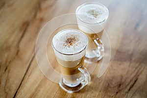 Home made coffee Cafe Macchiato on wooden table. photo