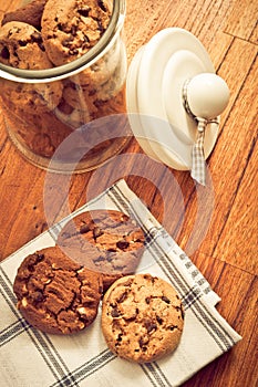 Home made cookies biscuits with cacao chips in glass jar in rustic style