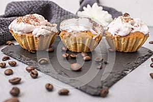 3 home made cupcakes on a black stone tile