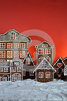 Home made gingerbread village with red background