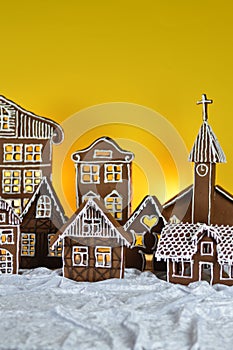 Home made gingerbread village with yellow background