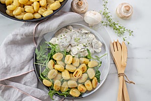 Home made gnocchi with mushrooms and arugula salad