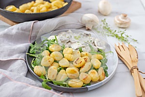 Home made gnocchi with mushrooms and arugula salad