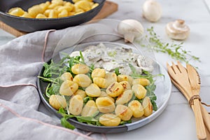 Home made gnocchi with mushrooms and arugula salad