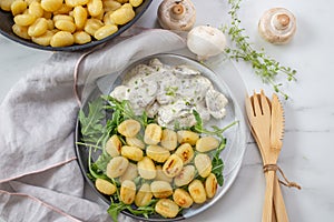 Home made gnocchi with mushrooms and arugula salad