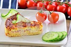 Home made ham and cheese quiche with tomatoes and cucumber