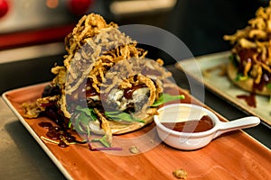 Home made hamburger with lettuce, cheese, beef meat and french fries placed on stainless steel table