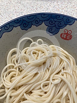 Home made hand pulled noodles in bowl with auspicious clouds