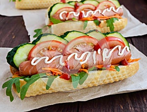 Home made hot dogs with vegetables, juicy sausage and arugula