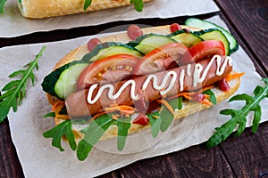 Home made hot dogs with vegetables, juicy sausage and arugula