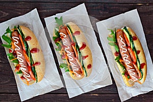 Home made hot dogs with vegetables, juicy sausage and arugula