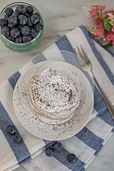 Home made lemon pancakes with poppy seeds on a breakfast table