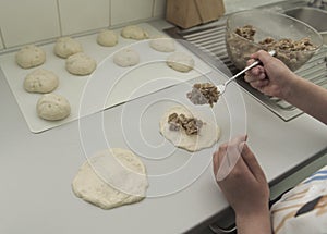 Home-made minced meat pies. Children`s first experience in the kitchen