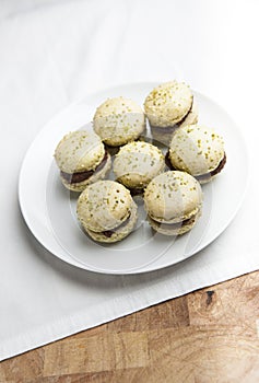 Home-made pistachio macaroons on white plate