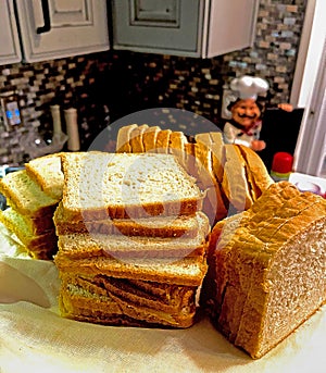 Home-made Sandwich Bread Sliced on Cutting Board with two glasses of Wine