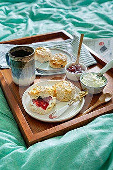 Home made scones with strawberry jam  clotted cream served in bed.