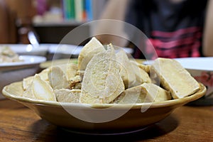 Home made of snack and dessert, Chinese Traditional Deep Fried Tofu or Fried Bean Curd Served in dish on wooden table