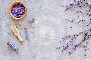 Home spa with lavender herbs cosmetic salt for bath on stone desk background top view mock-up