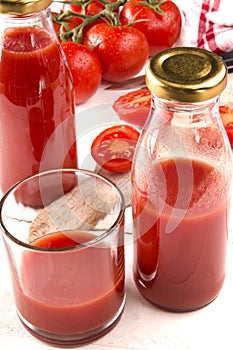 Home made tomato juice in a glass and bottle